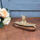 Vintage cat fish catchall in brass on a solid wood base.
