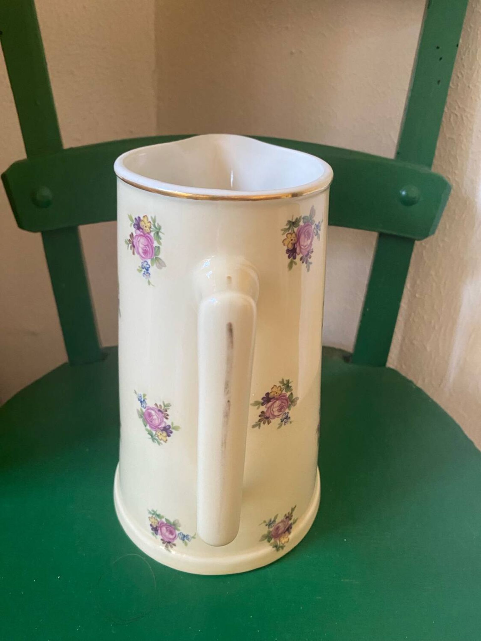 Old flowery and gilded pitcher.