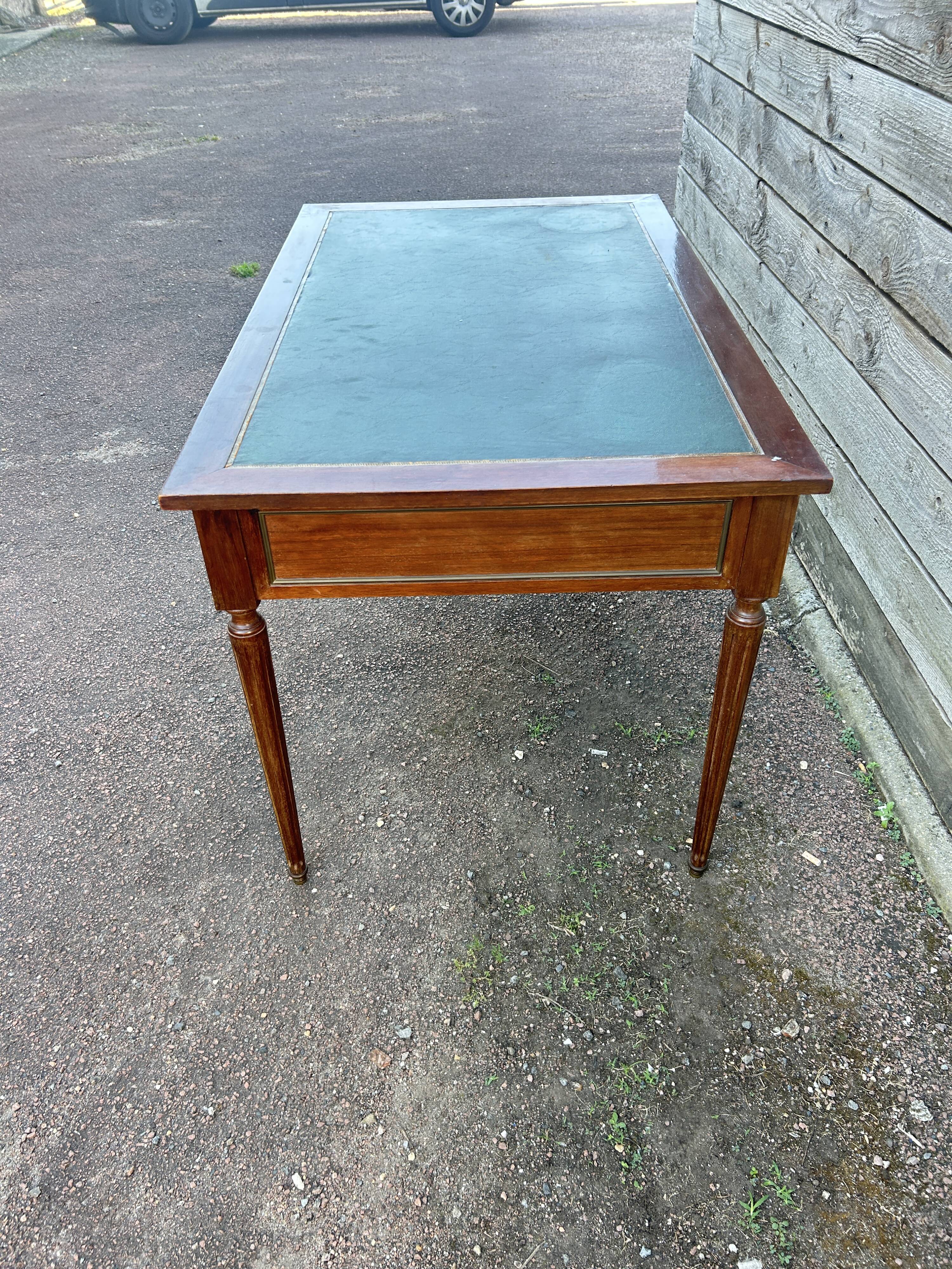 Louis XVI style desk in mahogany with a green leather top.