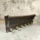 Vintage wall-mounted coat rack in solid wood.