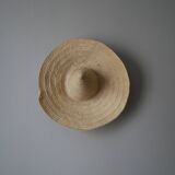 Hand-woven wicker straw hat, artisanal production, decorative object, bohemian ethnic countryside