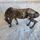 Sculpture of a grazing horse with a silver finish.