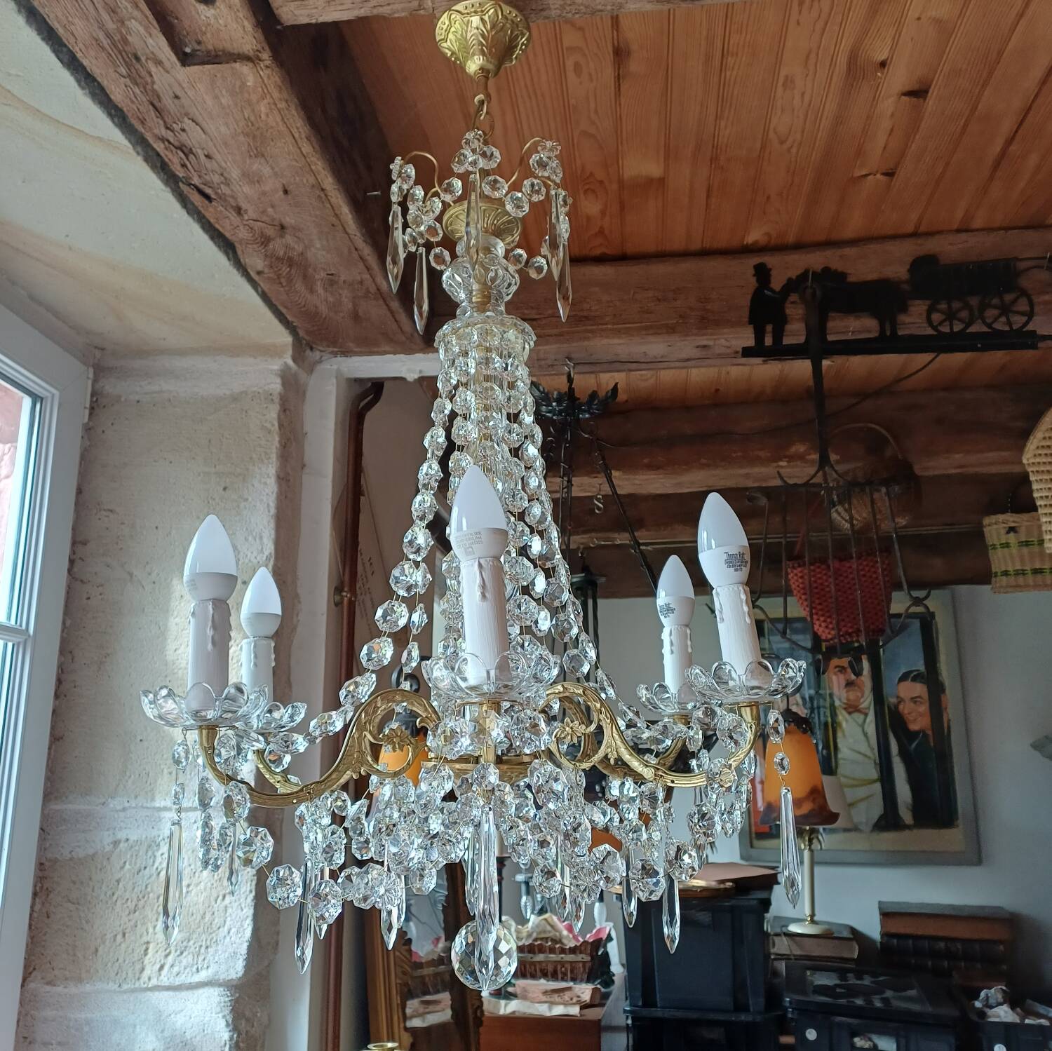 Antique chandelier with pendants in bronze and crystal.