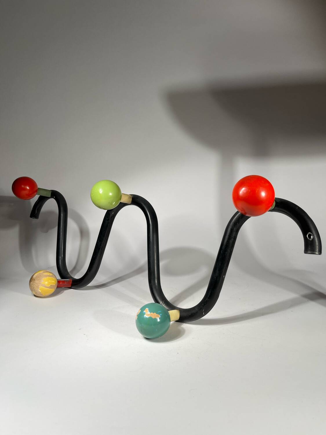 Coat rack in black lacquered metal and colored wooden balls