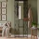 Large vintage wall coat rack in wrought iron with mirror and shelf.