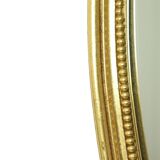 Miroir ovale doré de style Hollywood Regency