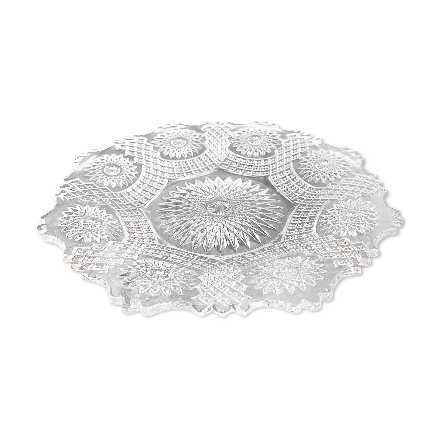 Vintage pressed glass plate with rosette design, octagonal rim, star pattern reminiscent of mandala