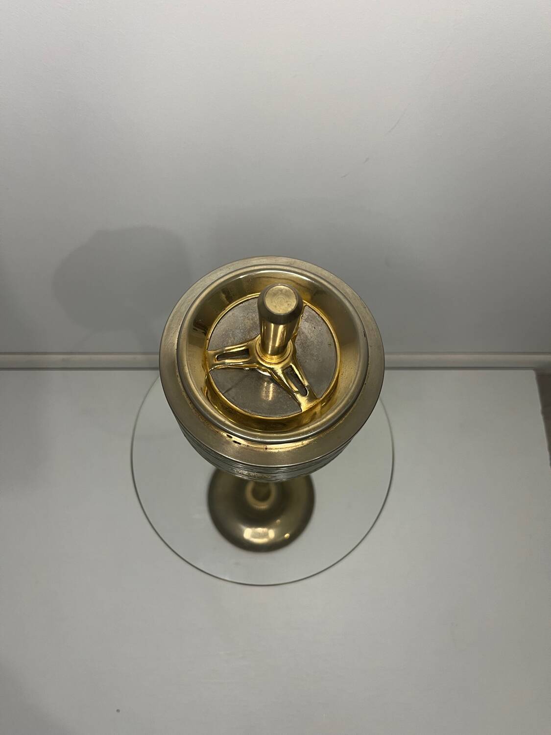 Vintage brass floor ashtray with glass shelf in Empire style.