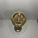 Vintage brass floor ashtray with glass shelf in Empire style.