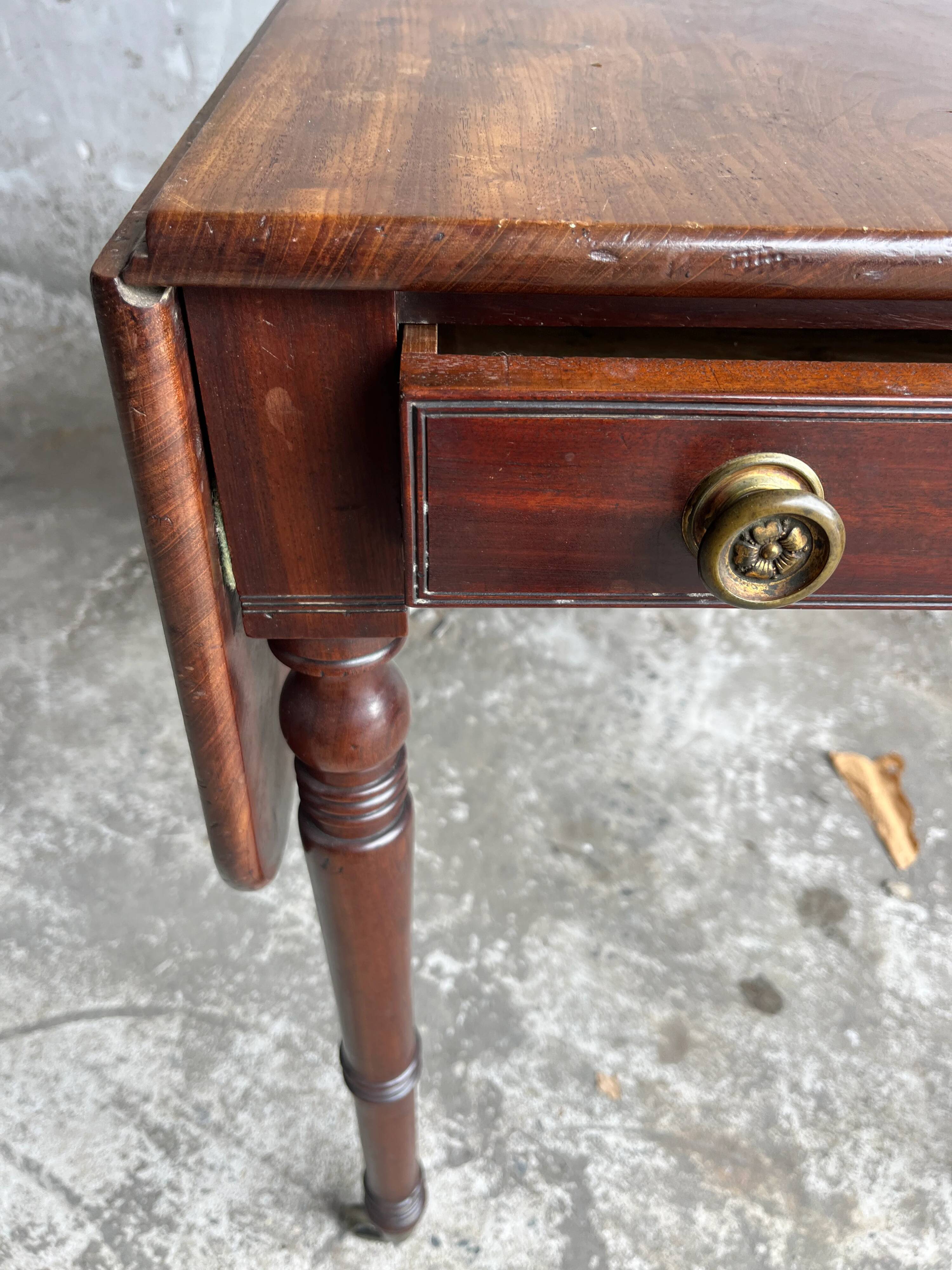 Antique drop-leaf side table on wheels