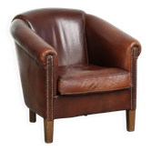 Characterful sheepskin club armchair in a dark cognac colour in English style