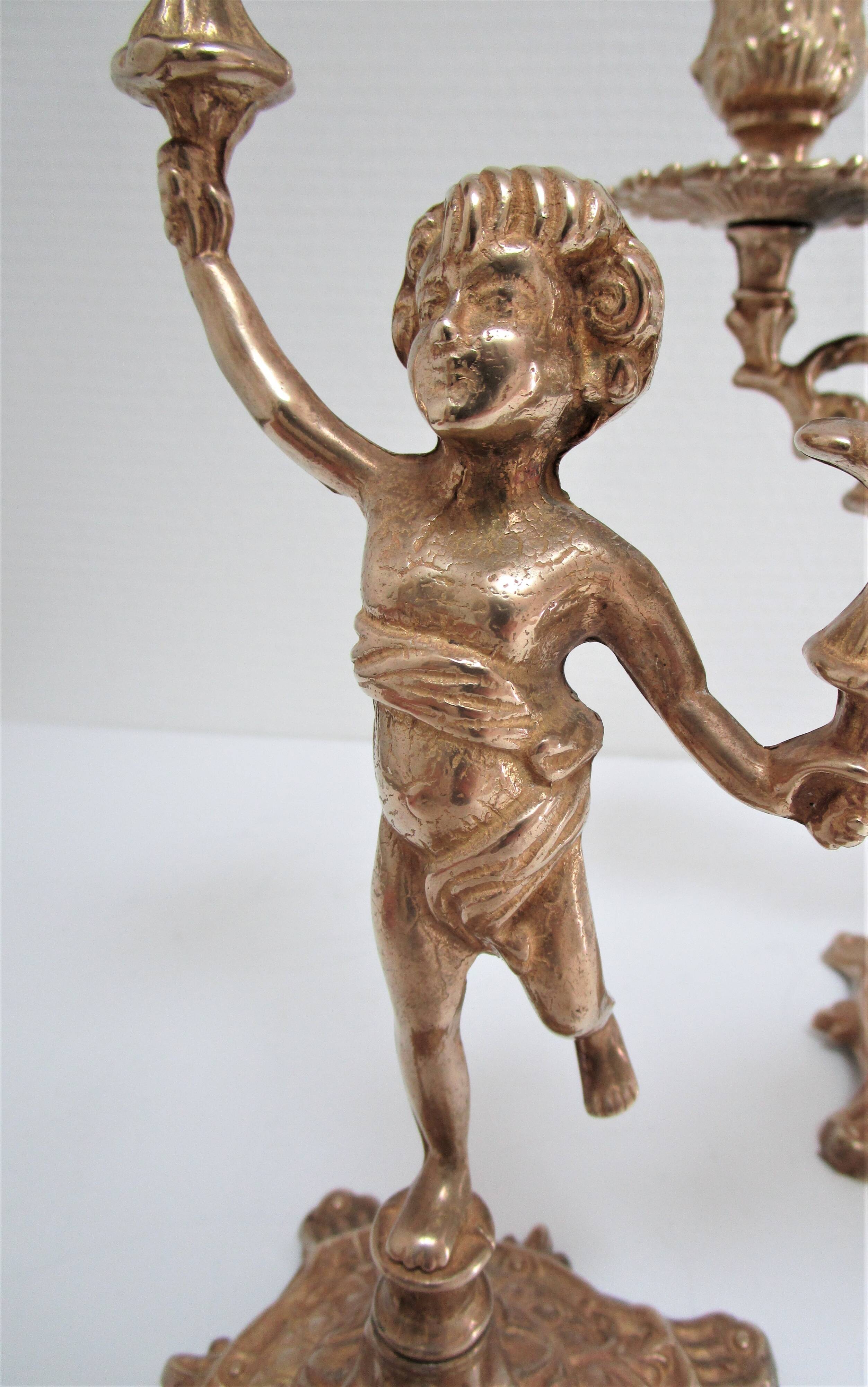 Pair of vintage golden brass cherub candlesticks