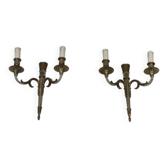 Pair of Louis XVI style wall sconces in bronze with an off-white patina