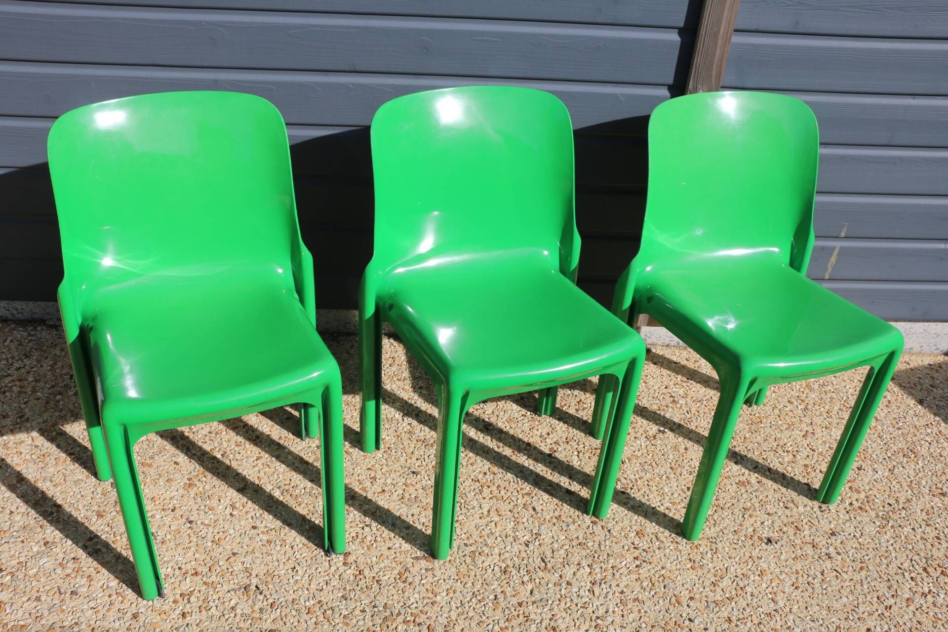 Set of 4 green Selene Magistretti chairs.