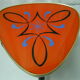 Plant holder tripod in geometrically patterned orange formica