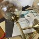 Pair of antique wall sconces torch style brass with glass globes in gold.