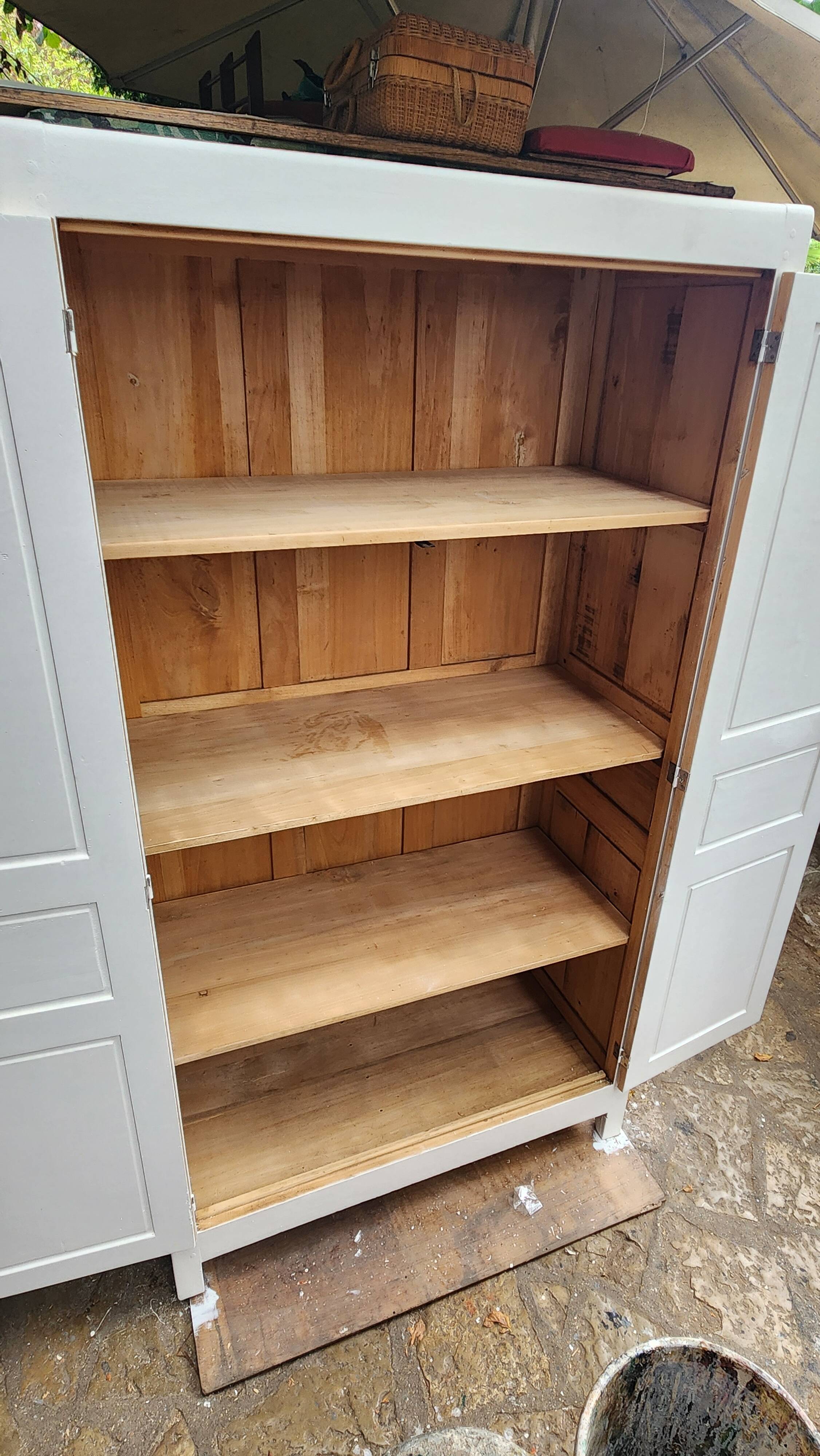 Antique Parisian wardrobe in white wood with shelves from the 1950s.