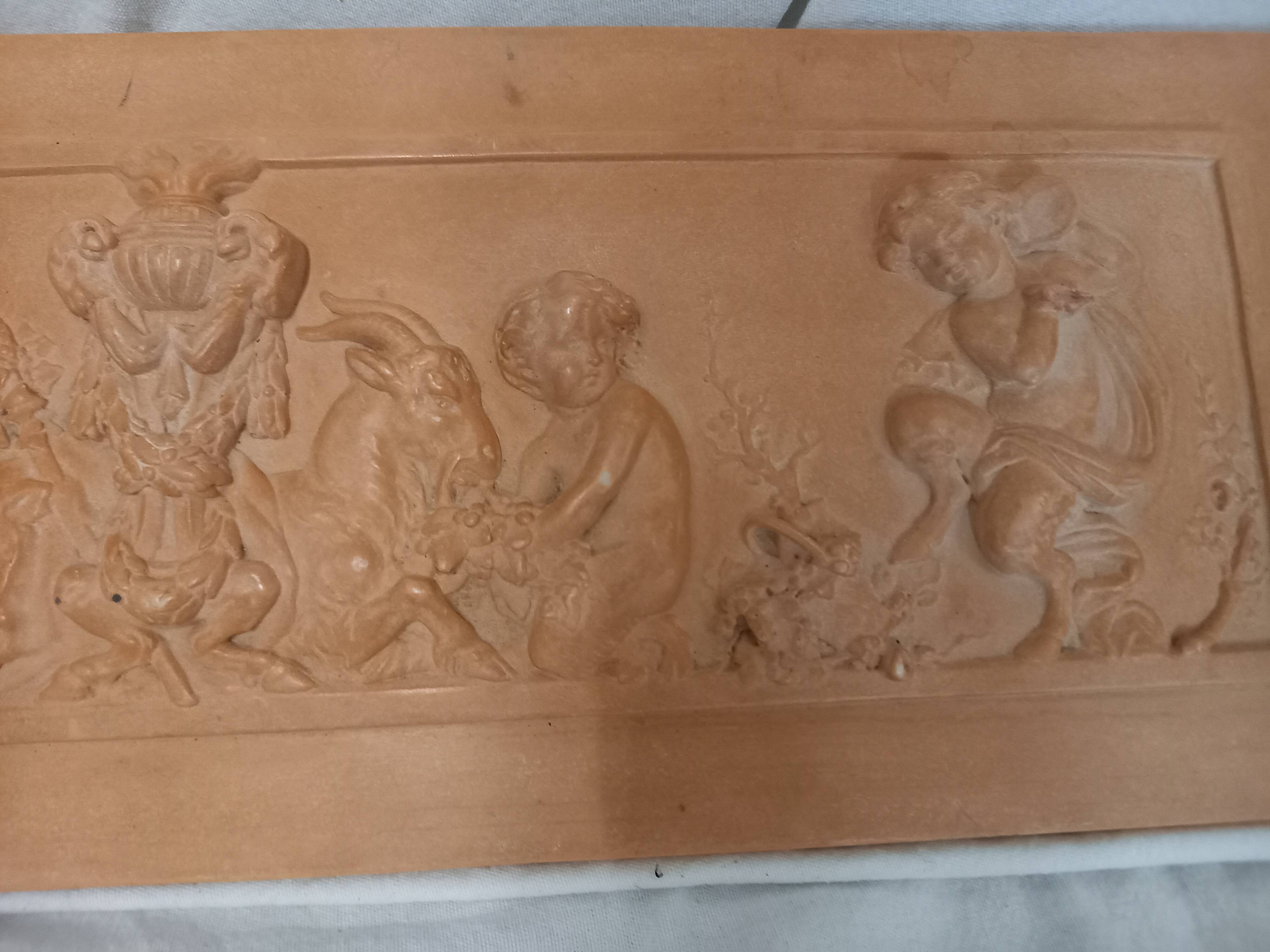 Bas relief, over door, terracotta, children and fauns harvesting grapes