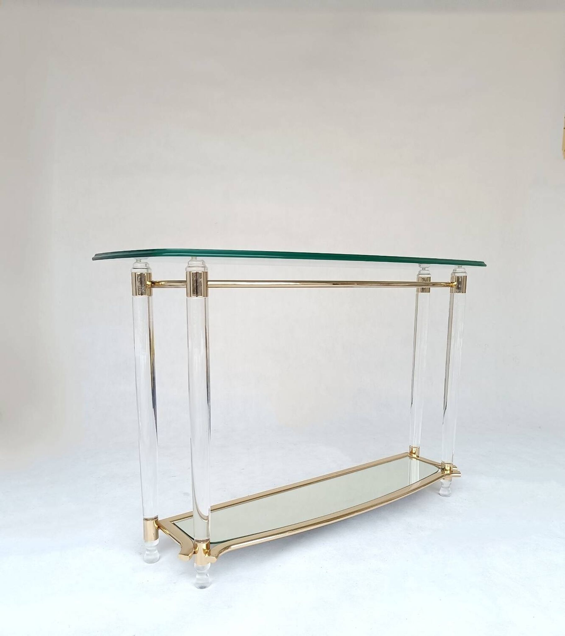 Hollywood Regency console table in lucite, glass and gold metal. 1980s