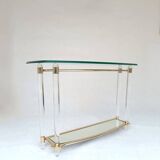 Hollywood Regency console table in lucite, glass and gold metal. 1980s