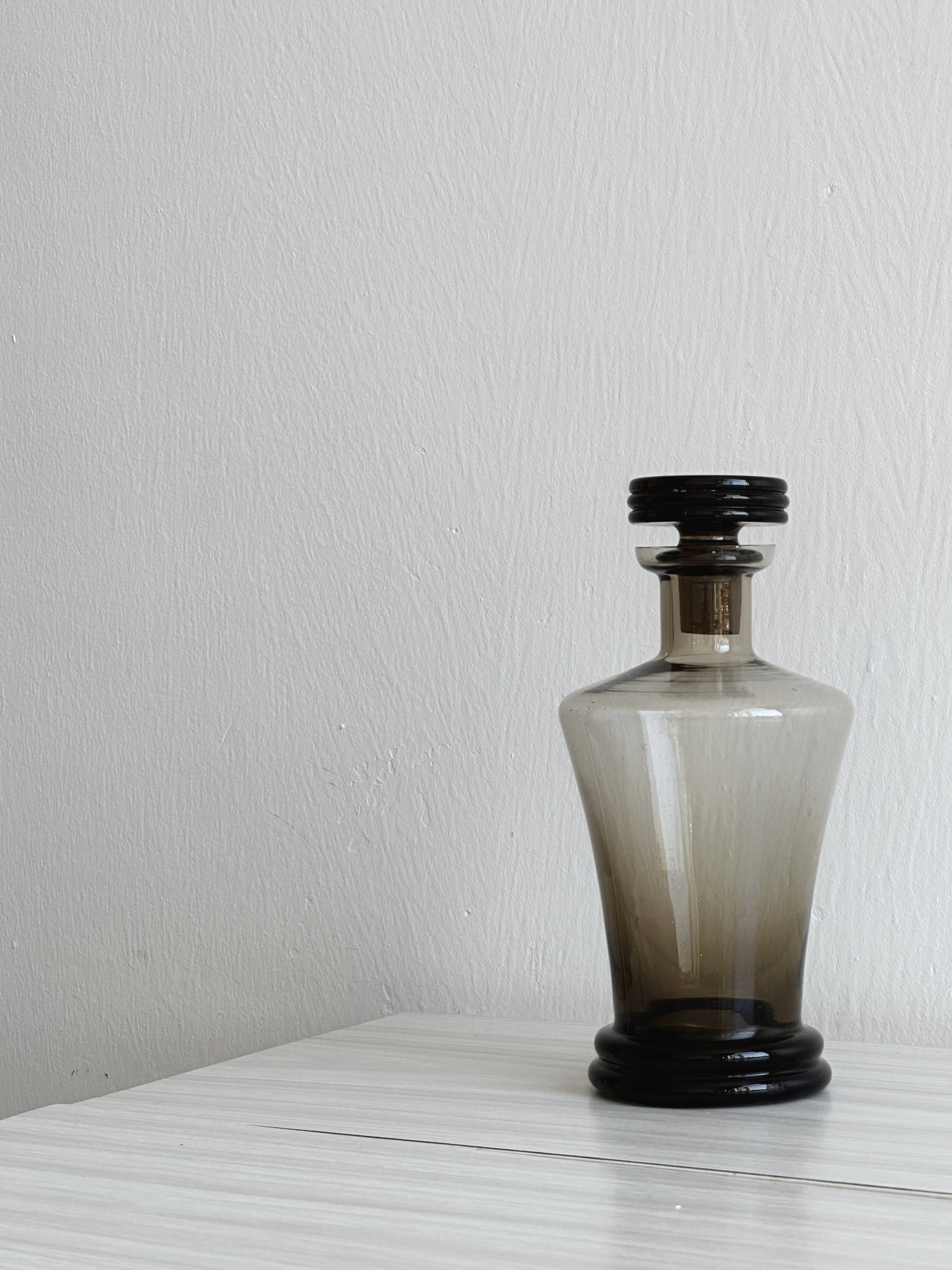 Smoked glass bottle, sculpted stopper