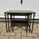 Nested tables in gilded brass in the style of Maison Charles.