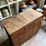 Craftsman's cabinet with 16 drawers in dark wood.