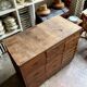 Craftsman's cabinet with 16 drawers in dark wood.