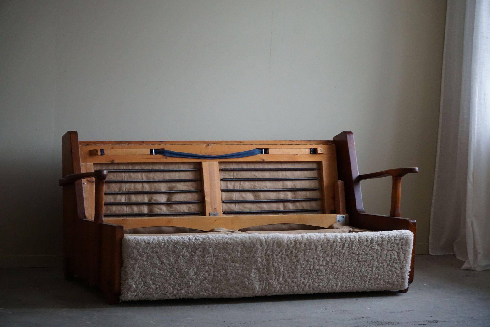 Modern Swedish two-seater independent sofa bed in pine and lambswool, 1950s.