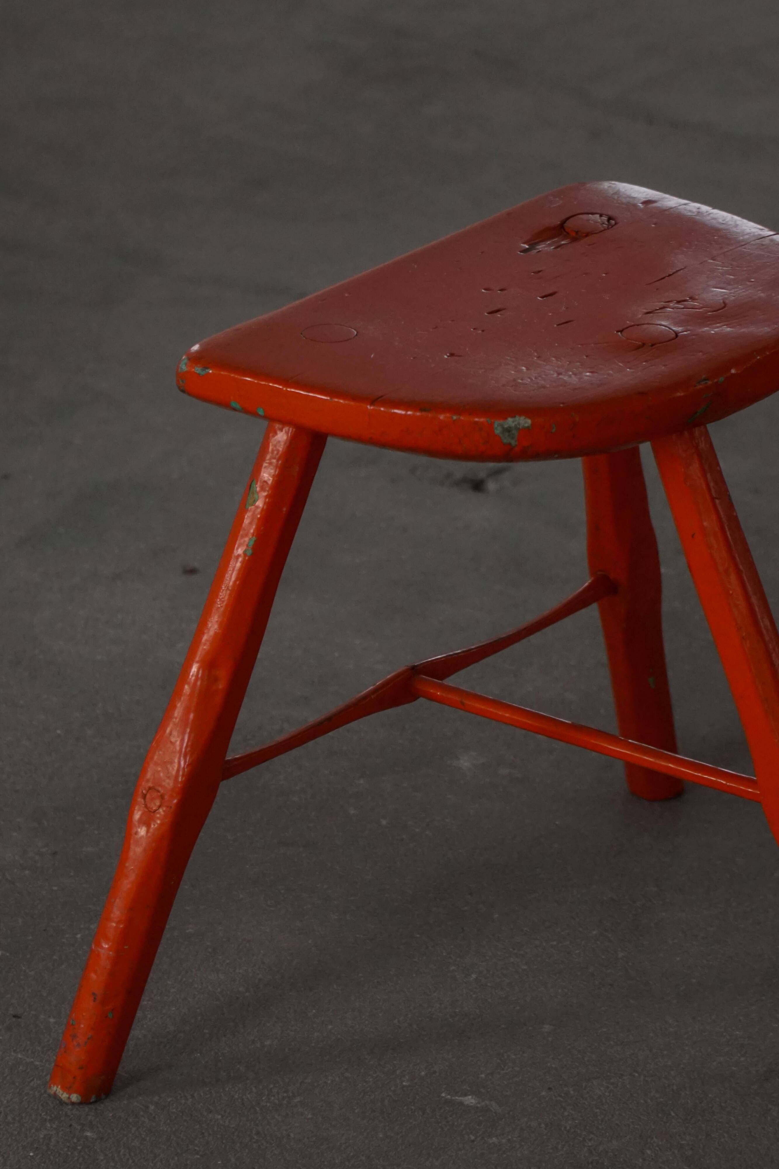 Pair of patinated wooden stools painted red with flared legs, 1950s-1960s.