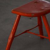 Pair of patinated wooden stools painted red with flared legs, 1950s-1960s.