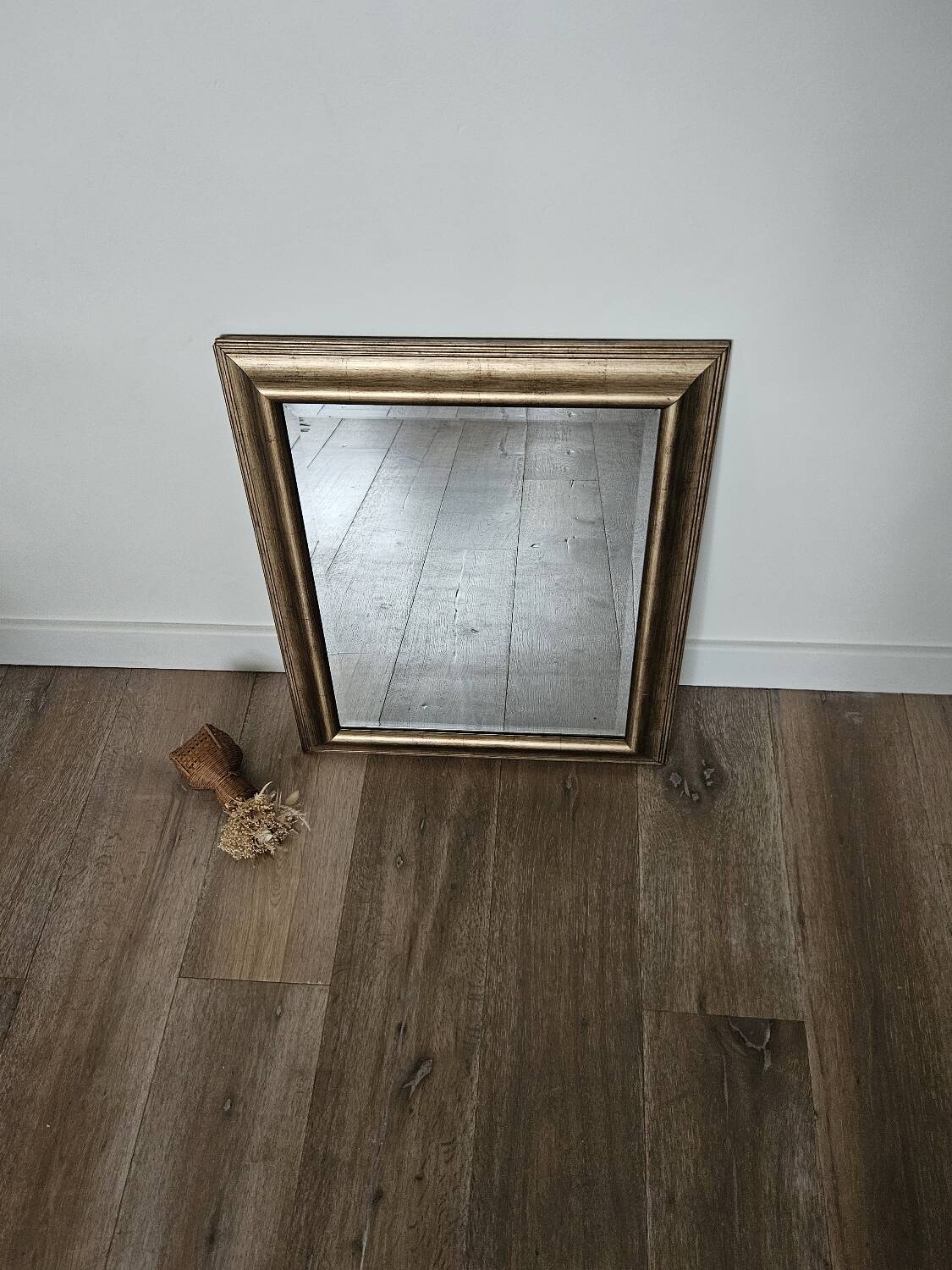 Beveled mirror under gold frame