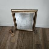 Beveled mirror under gold frame