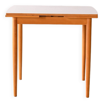 Extendable dining table with clear formica top