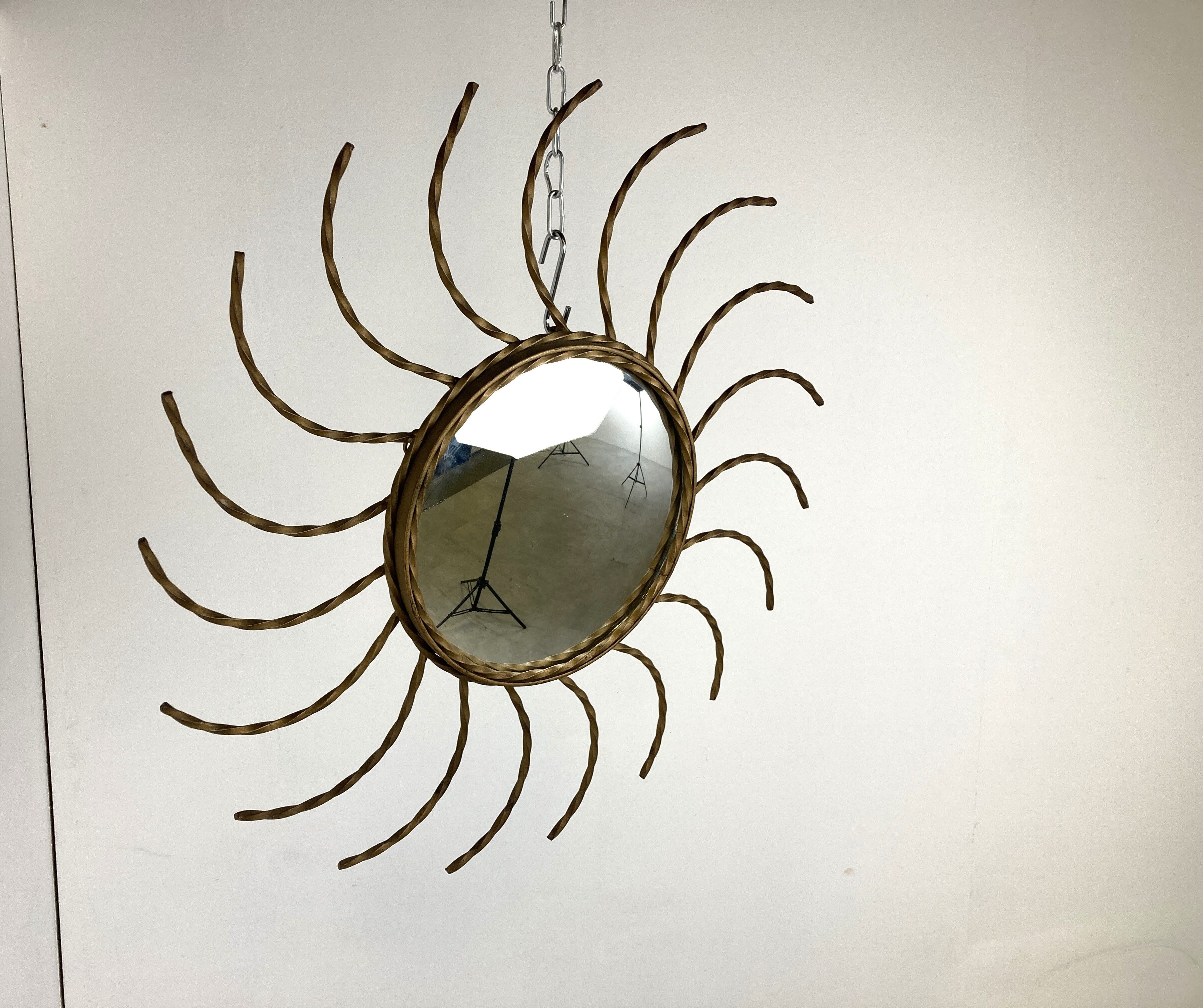 Mid century gold sunburst mirror with convex glass.