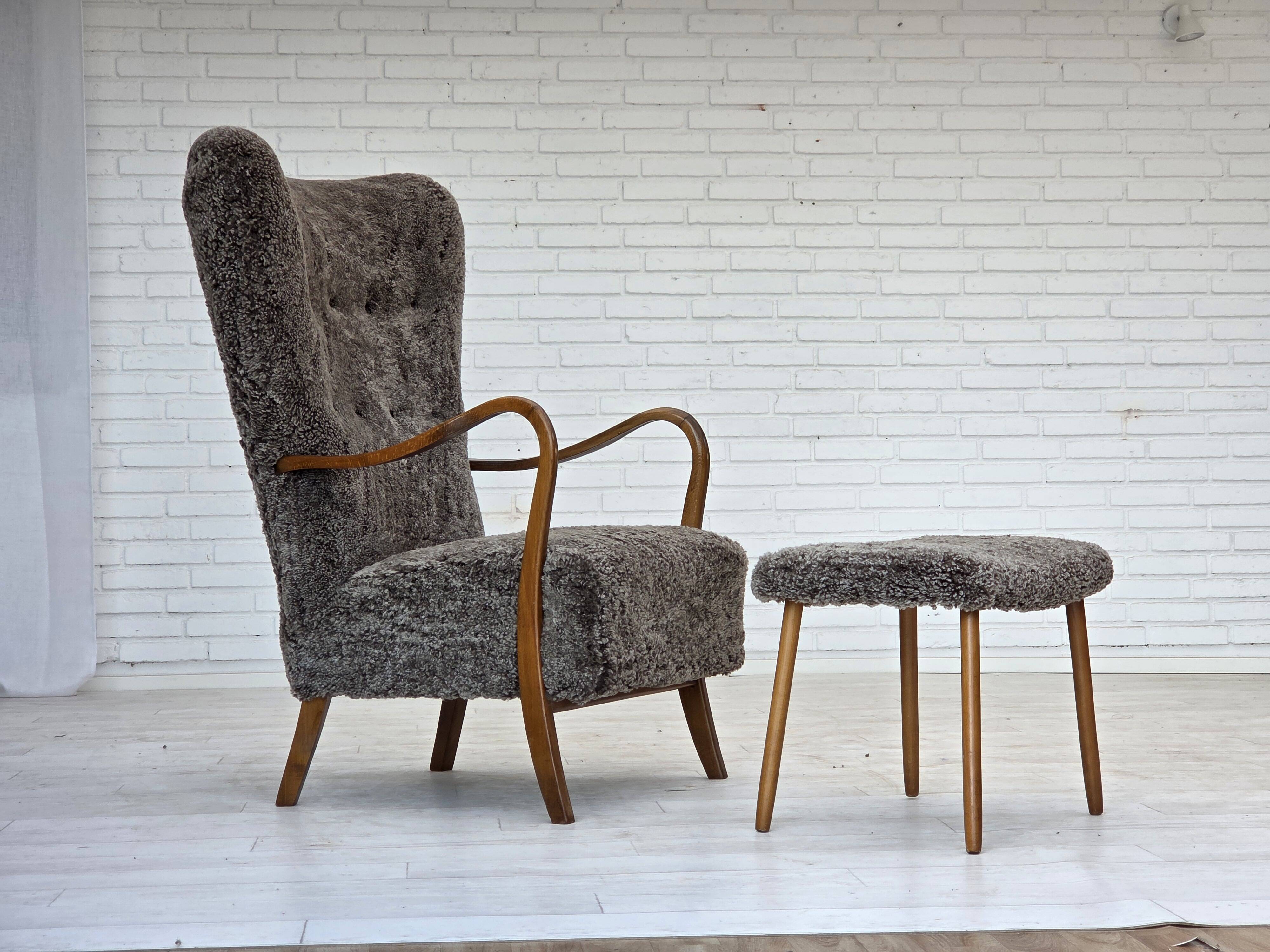 1960s, reupholstered Danish armchair, with stool, genuine sheepskin.