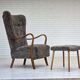 1960s, reupholstered Danish armchair, with stool, genuine sheepskin.