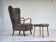 1960s, reupholstered Danish armchair, with stool, genuine sheepskin.