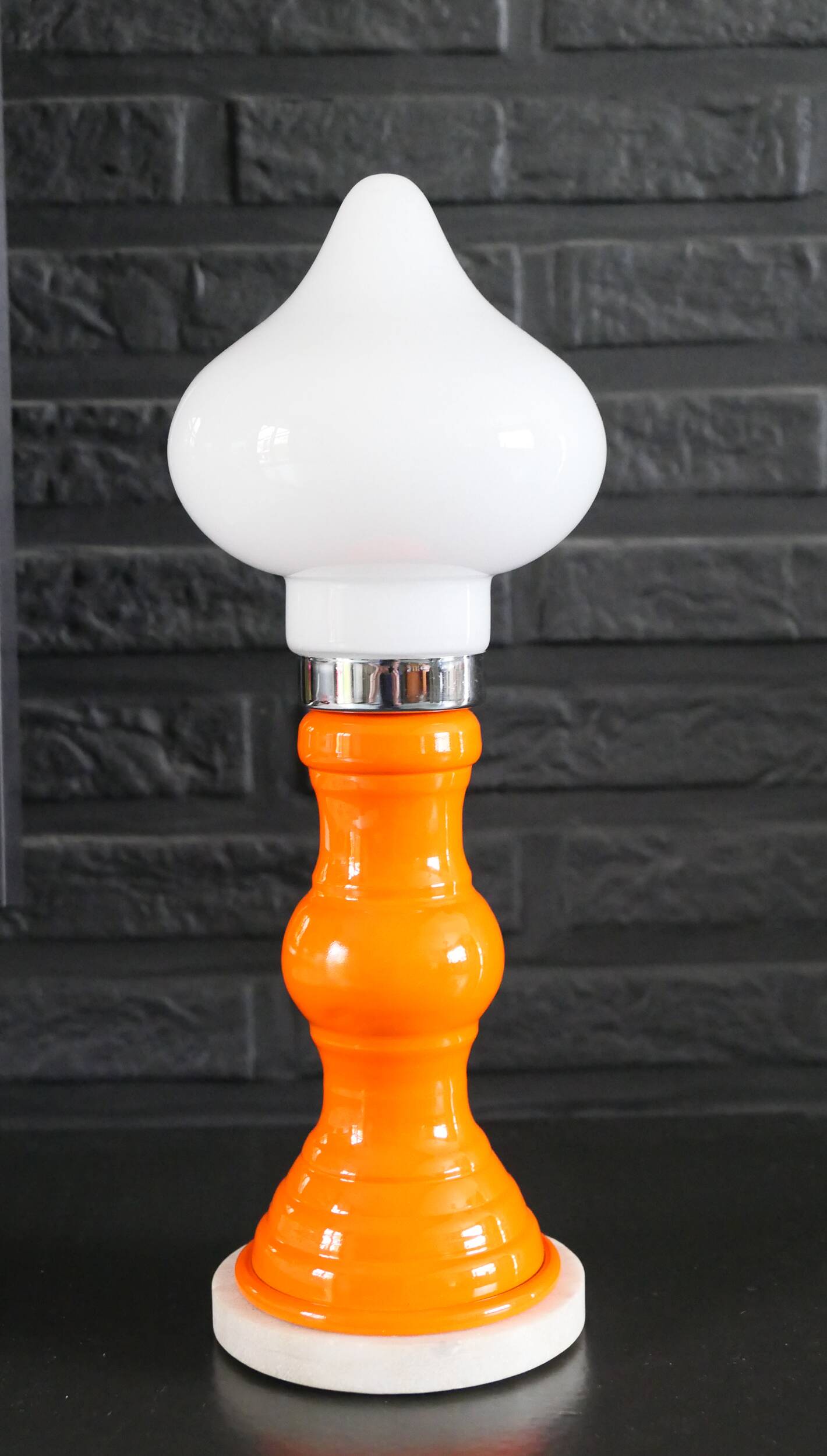 Table lamp or bedside lamp from the 1960s-70s in orange and chrome.