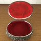 Metal jewelry box inside felt red floral decorations