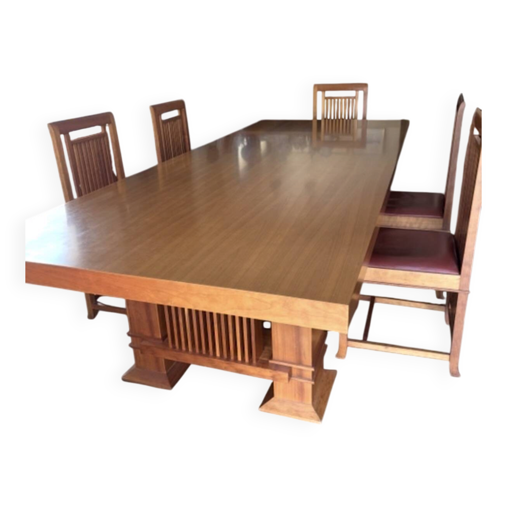 "Frank Lloyd Wright set with a table and its eight chairs."