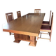 "Frank Lloyd Wright set with a table and its eight chairs."