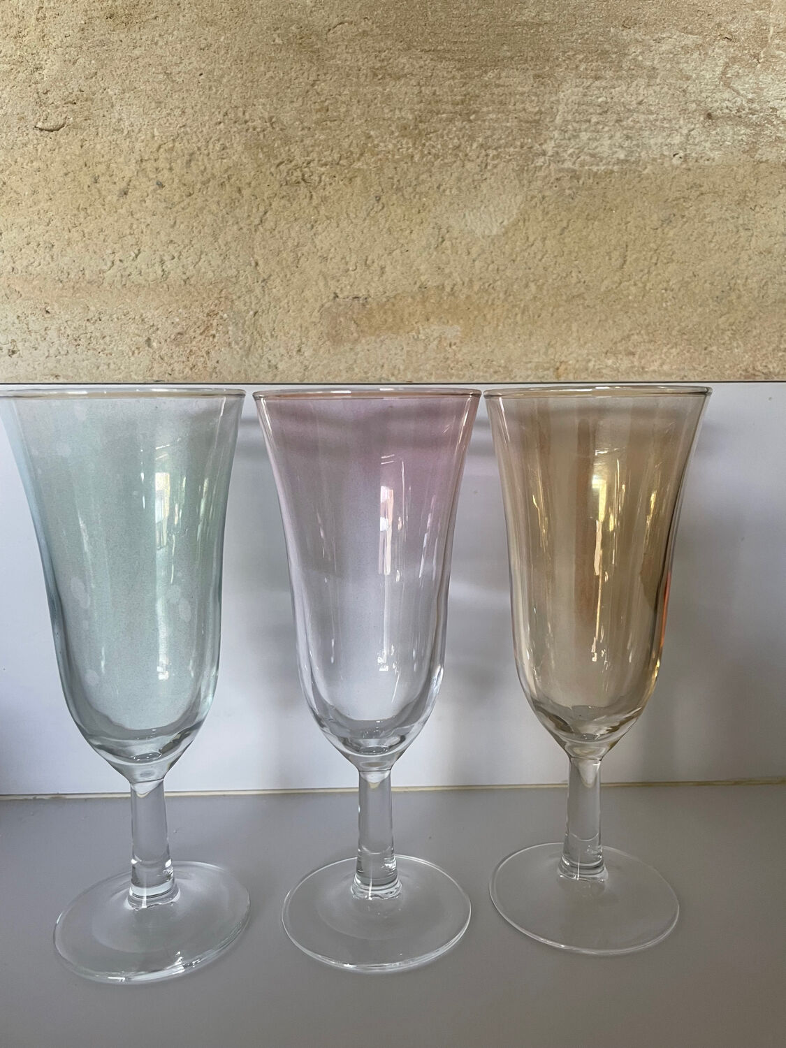 3 iridescent colored champagne glasses