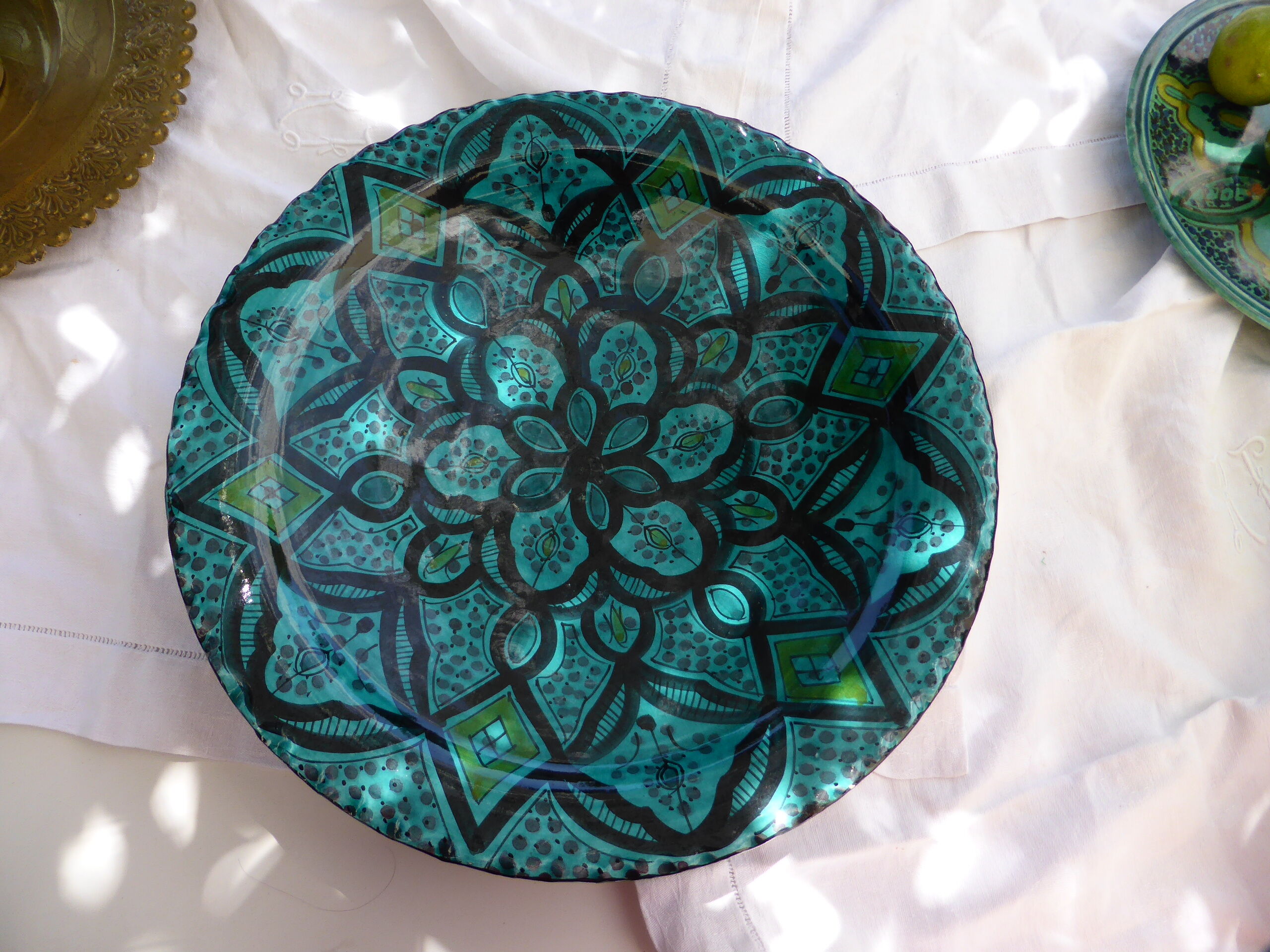 Hand-painted vintage oriental hollow dish, black patterns on a turquoise background