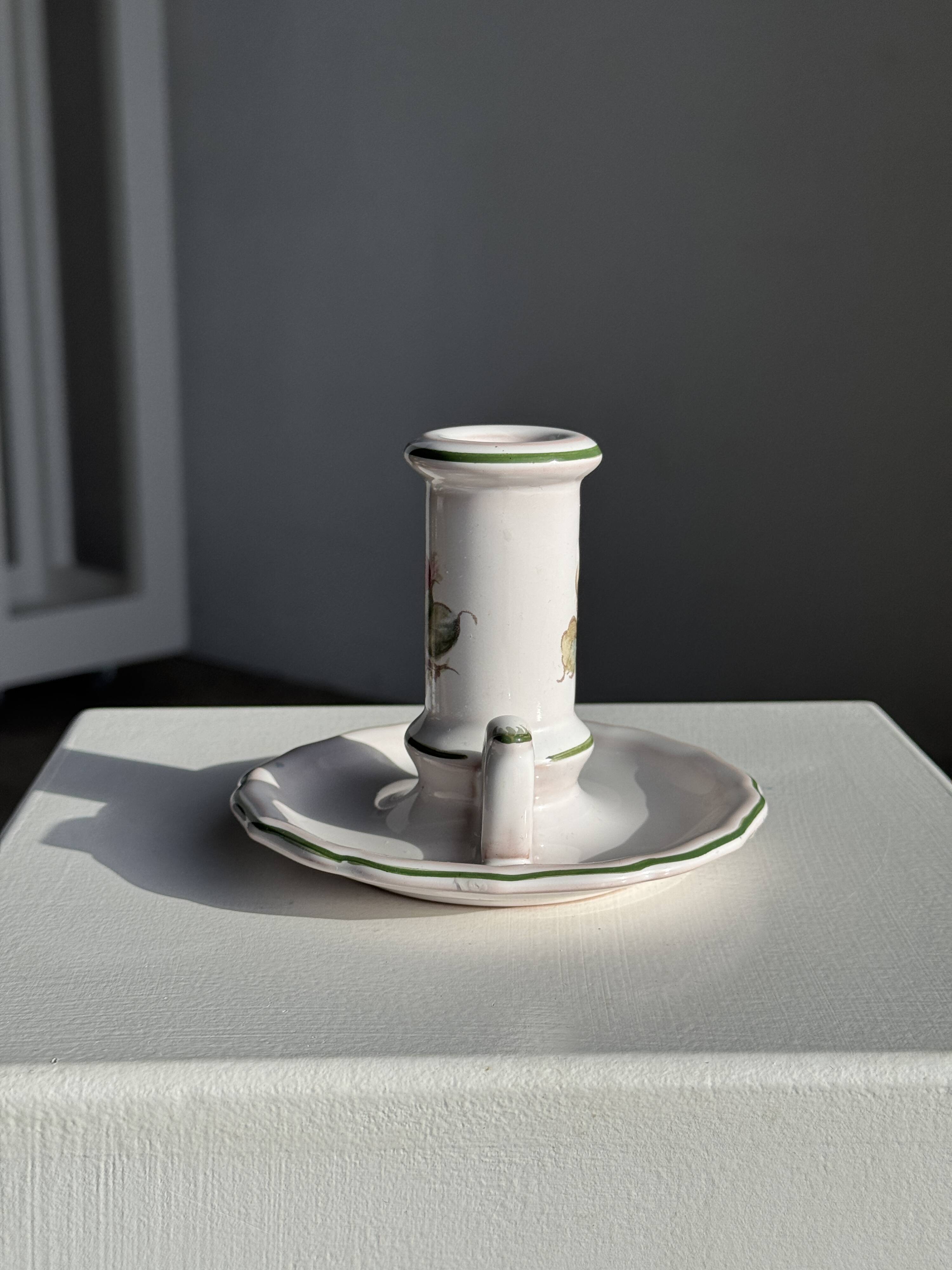 Small vintage hand-held candlestick in earthenware with green trim and floral decoration H10.5