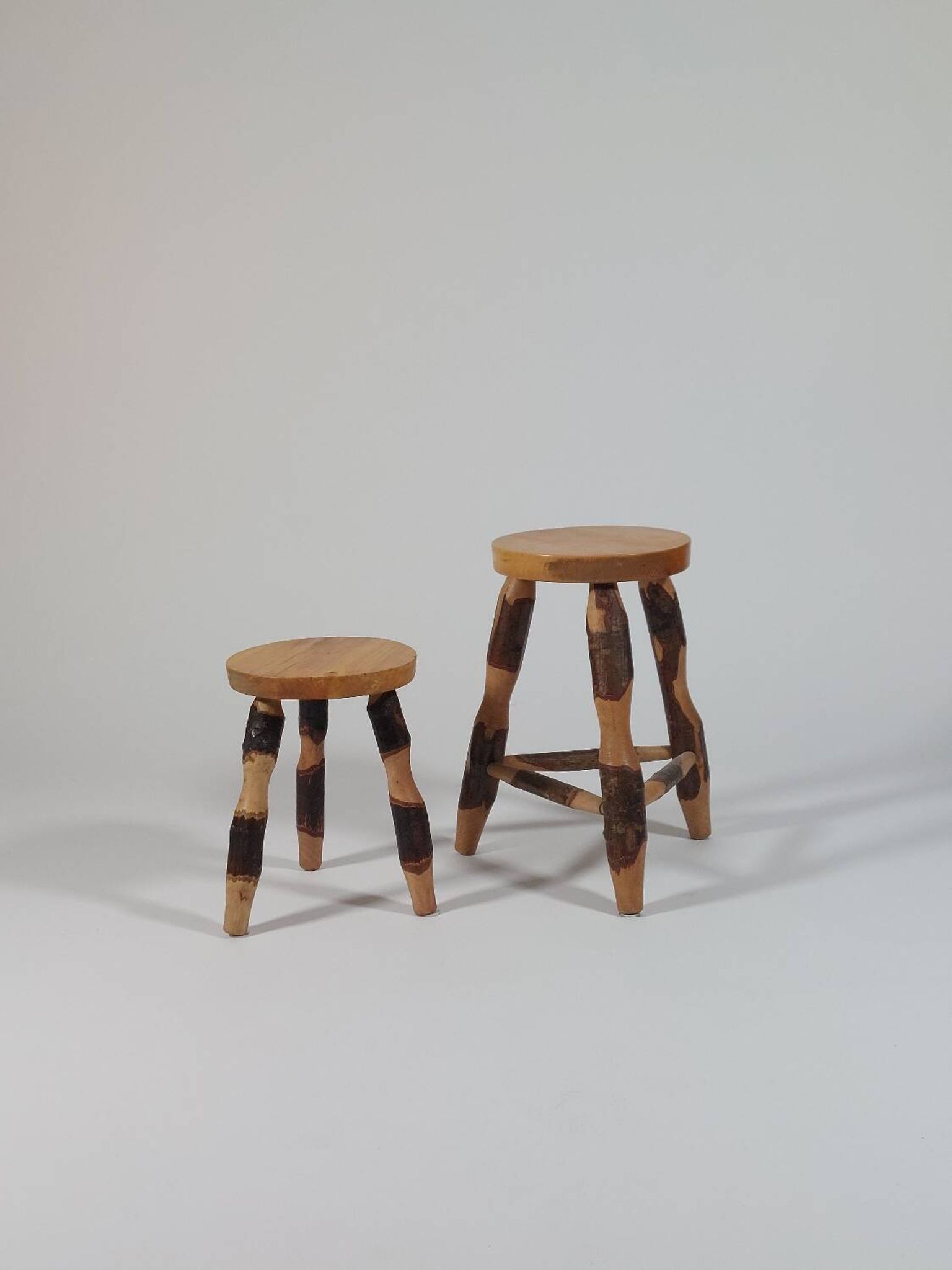 Pair of walnut stools sculpted in a vintage mid-century cross-section.