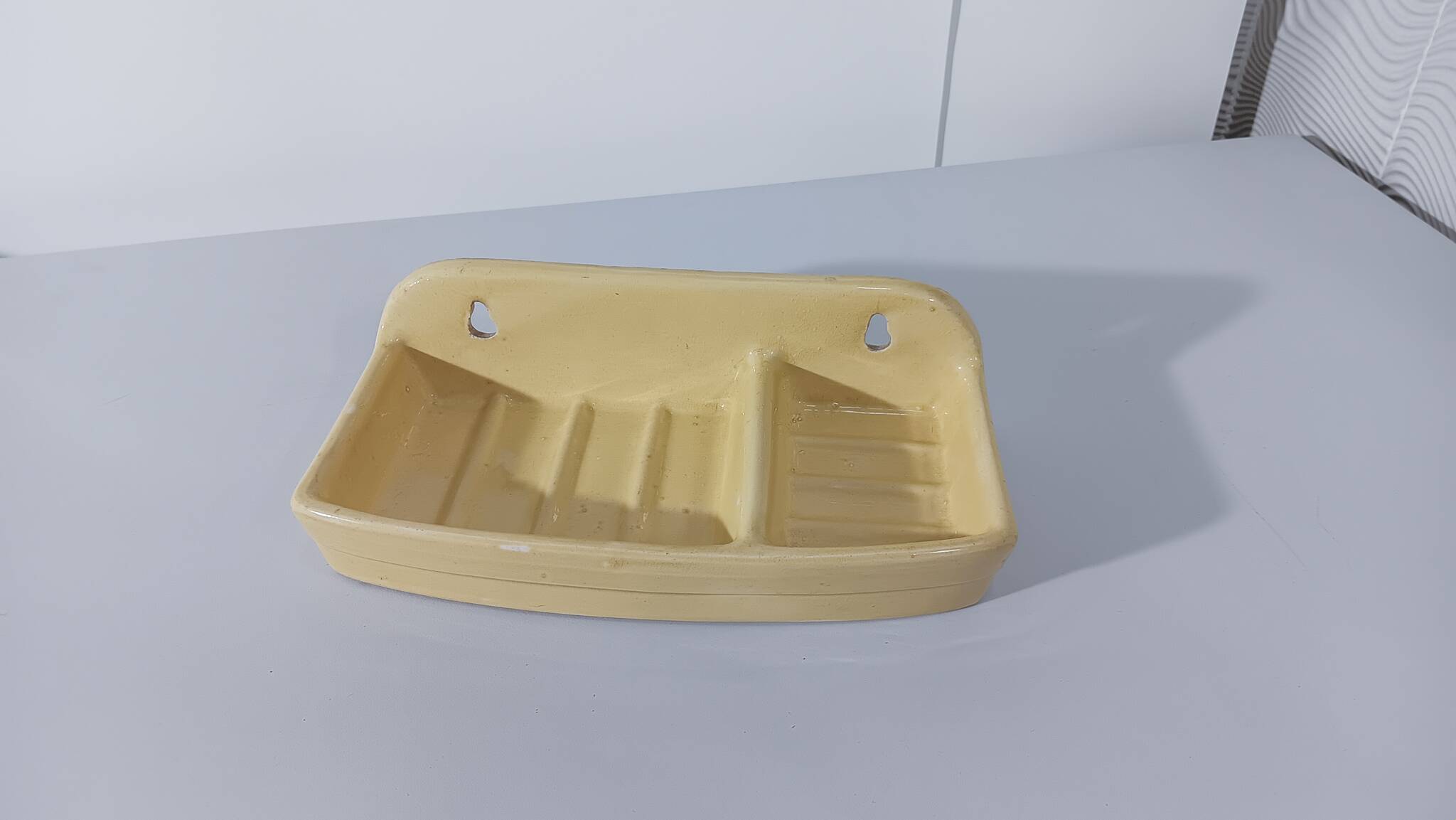 Pale yellow ceramic soap dish