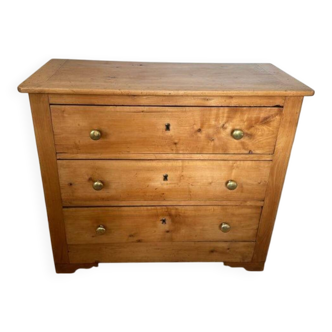 Rustic English pine chest of drawers with porcelain knobs.