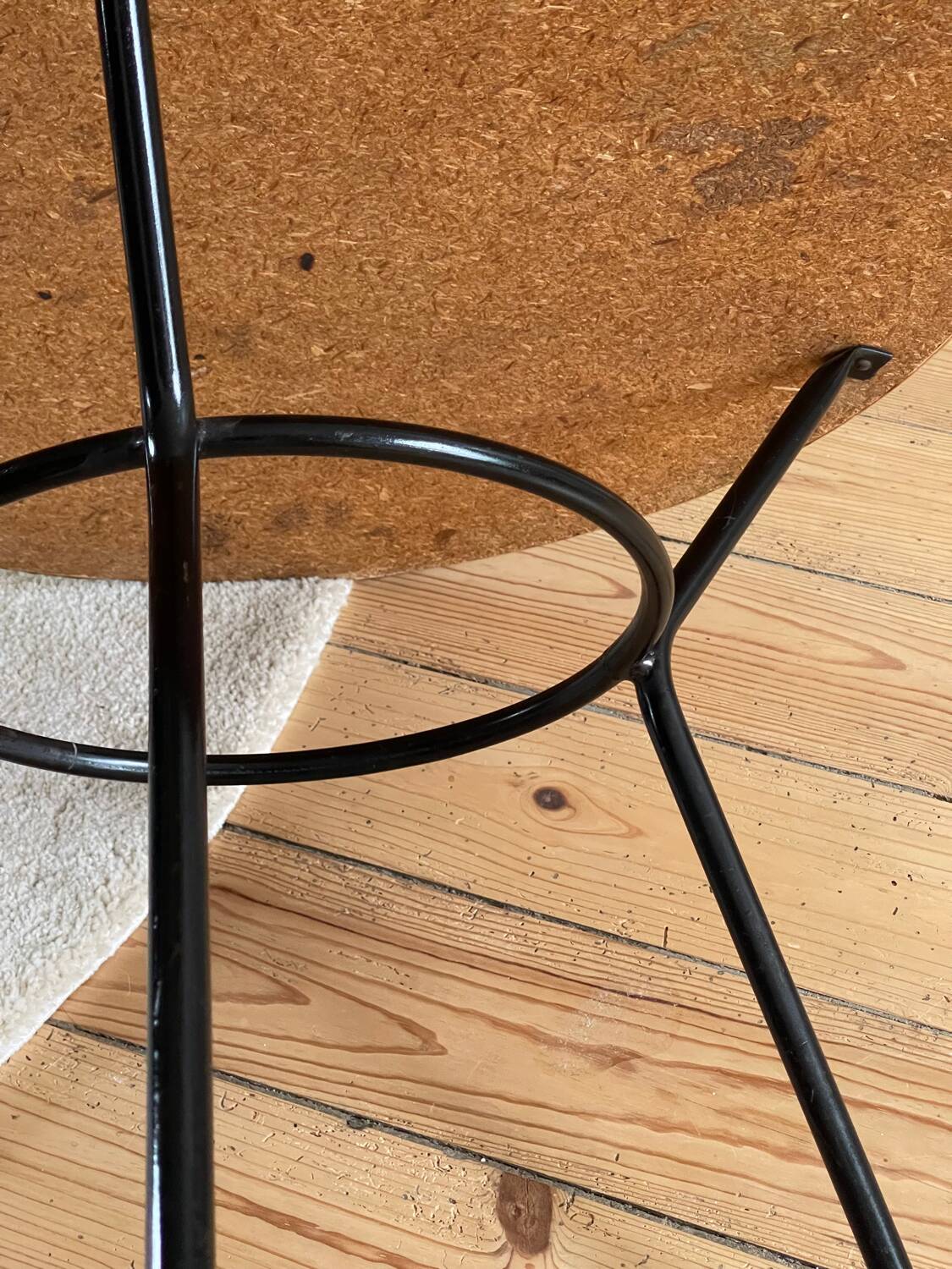 Tripod coffee table with a straw covering.