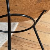 Tripod coffee table with a straw covering.